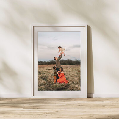 framed family photo of family playing in field by Joplin MO family photographer