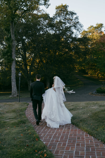 Bride and Groom sitting at wedding table embracing and looking into each others eyes