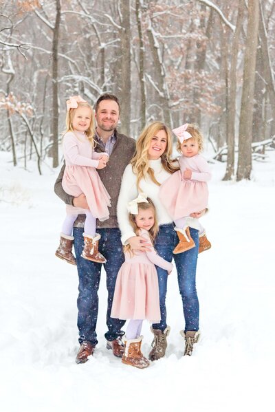 Family of five with three young daughters in the snow by Chicago family photographer Kristen Hazelton