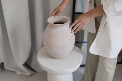 Martina Biljan, copywriter and creative brand strategist, placing a vase on a pedestal