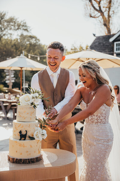 bride and groom cut cake