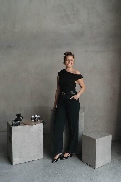 woman standing in a studio smiling