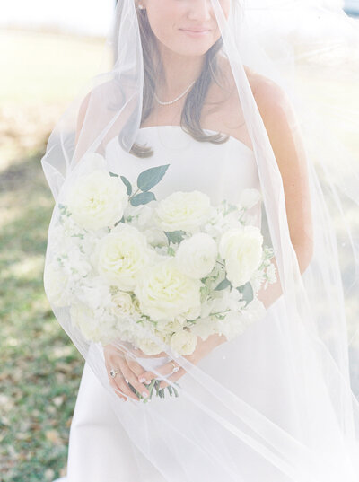 Bride wearing a cathedral length wedding veil on her wedding day in Bluffton, South Carolina