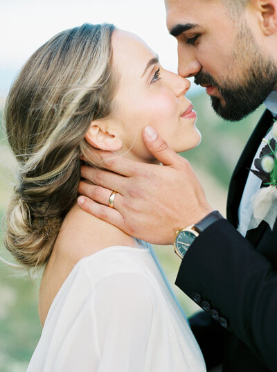 Close shot of groom holding bride's face in Los Angeles photographed on film