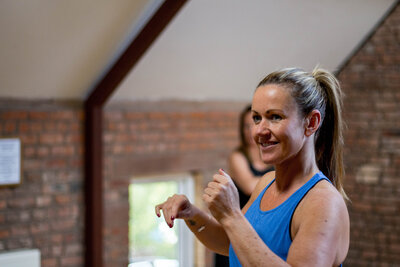 smiling woman during a workout with kt chaloner