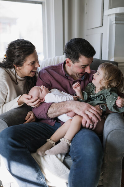 family laughing in chair