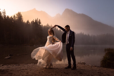 Eloped couple sit under waterfall near the Königsee in Germany