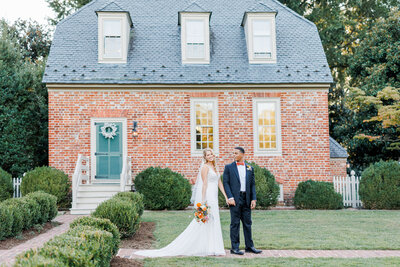 wedding couple walking in front of building