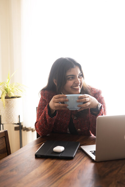 image of Maria John holding a coffee mug