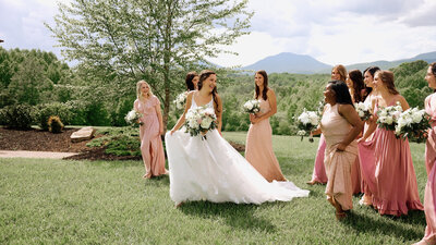 Bride and Bridesmaids  walk through field