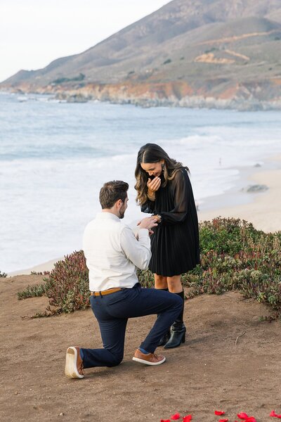 Big sur groom in black tux with white boutonniere