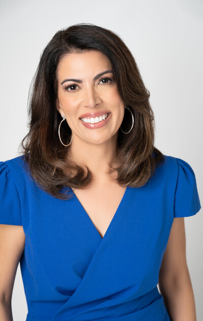 Spiritual success coach wearing a blue dress