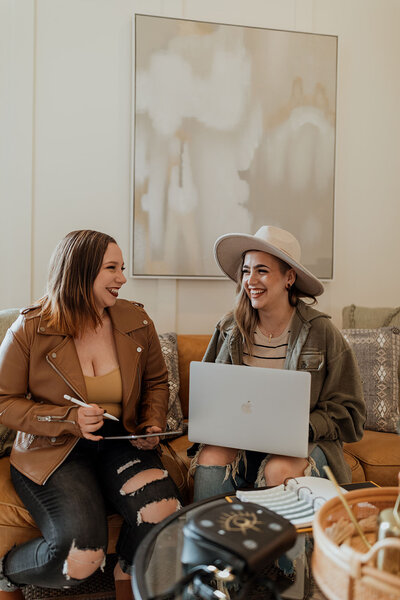 women sitting on couch