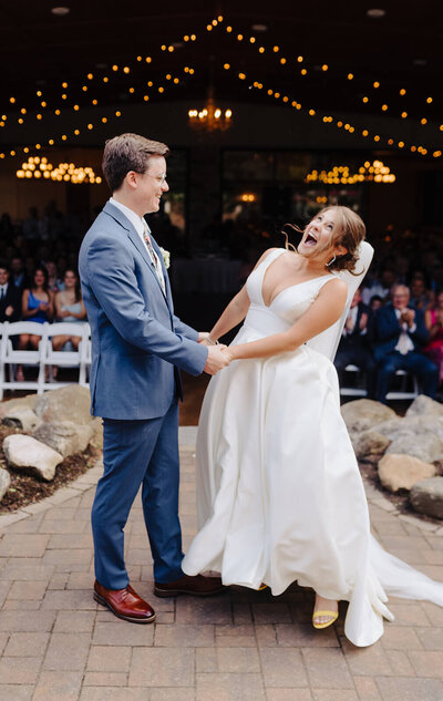 Groom holding his bride after their wedding ceremony at the Finger Lakes