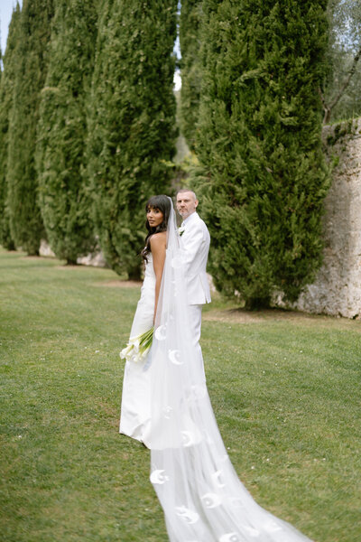 bride and groom walking on grass