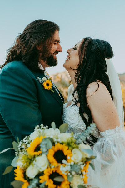 bride and groom smiling at eachother in sedona
