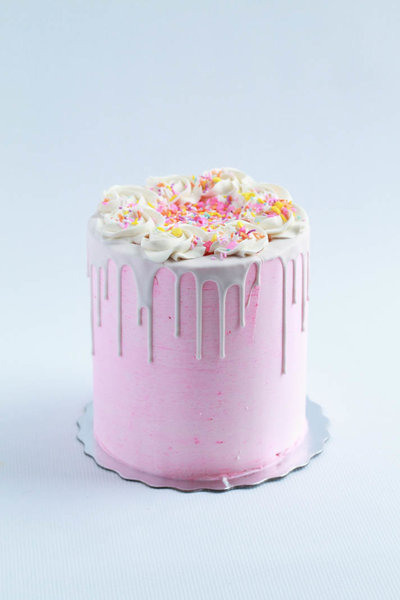 pink chocolate drip birthday cake with sprinkles