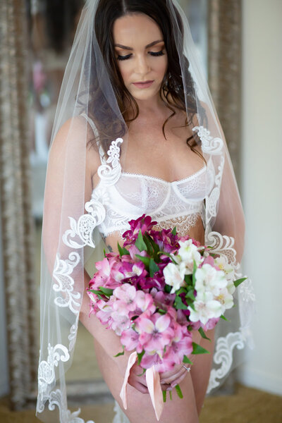 Bride wearing lingerie and florals