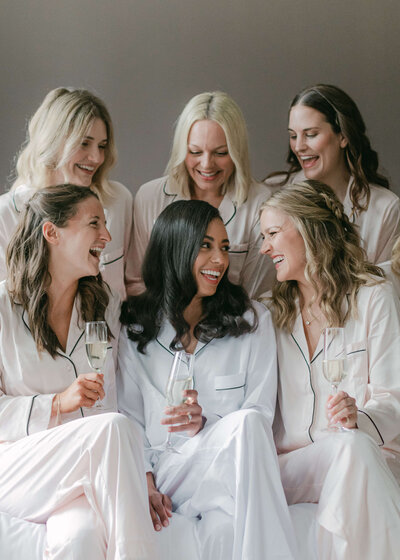 chloe-winstanley-weddings-bridesmaids-silk-pyjamas-bed-champagne