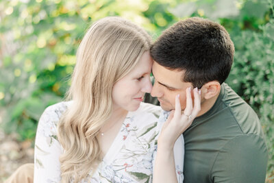 engaged couple snuggling taken by minneapolis wedding photographer
