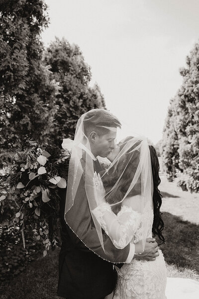 under the veil wedding photos of the bride and groom at Denver Botanic Gardens