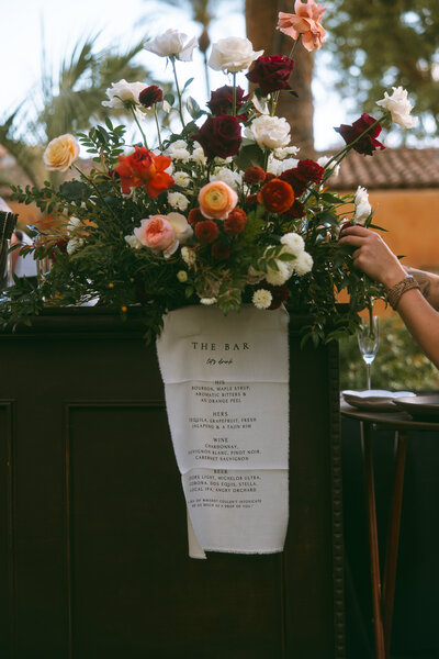 Lush floral arrangement for cocktail hour from wedding florist at Royal Palms Alegria Garden ceremony
