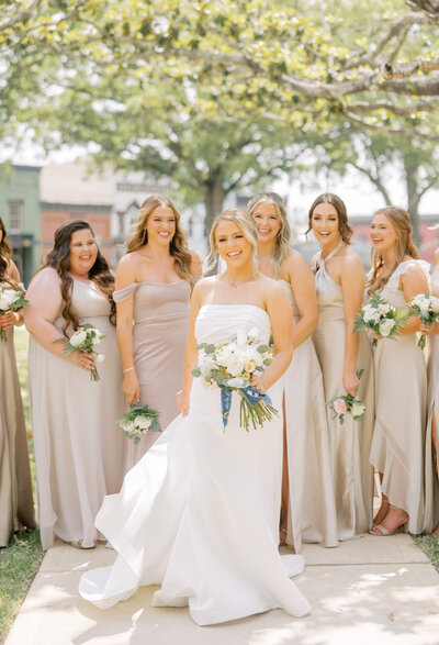 bride standing with bridesmaids