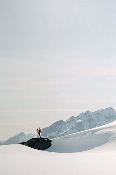Wedding couple on a remote rock on a mountain landscape