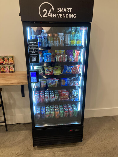 Smart vending machine with touchscreen and glass door, offering 24-hour access to drinks and snacks from Treehouse Vending