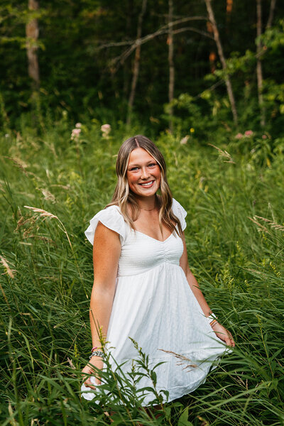 Senior girl in grassy field in Wedding Photography Minneapolis. 