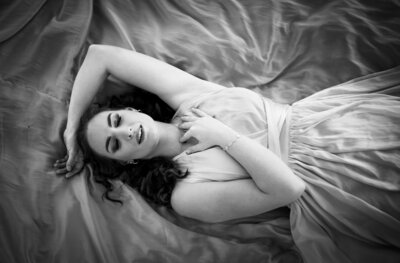 Women laying down on dress  in black and white