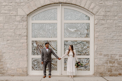 guelph city hall elopement bride and groom hold hands