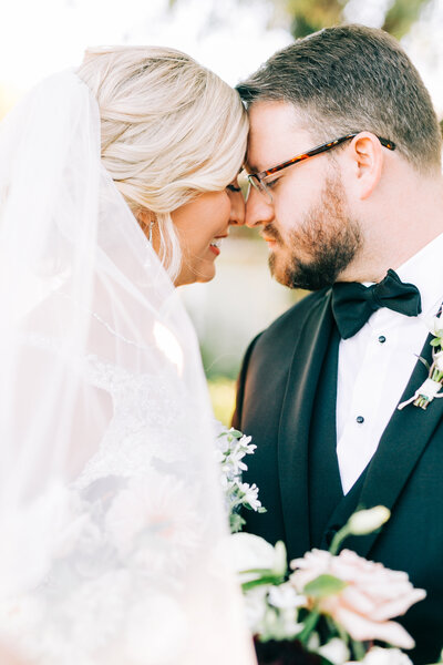 Bride and groom foreheads together smiling on wedding day by Winx Photo, Knoxville Wedding Photographer