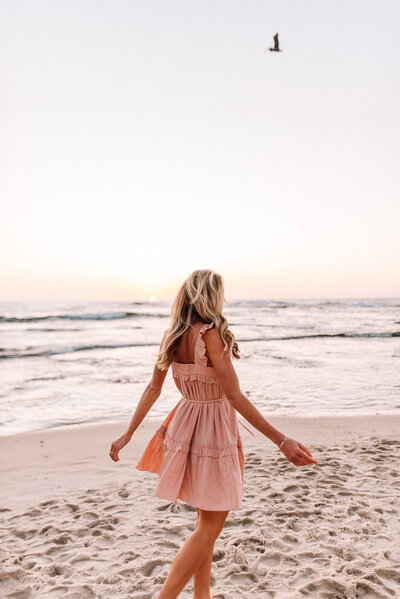 Woman on a beach in pink dress