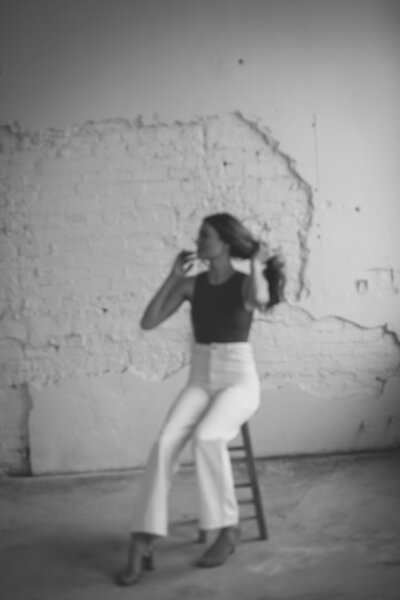 black and white image woman sitting posing