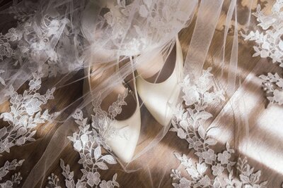 Bridal shoes and floral lace veil