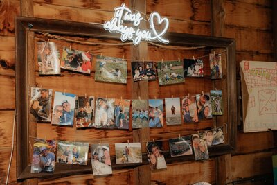 Photo wall display with a neon sign
