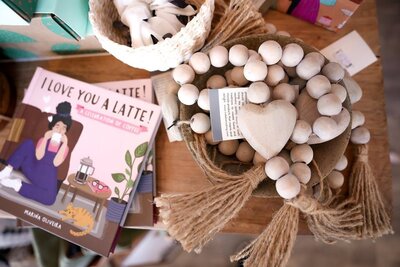 Beautifully styled product photo featuring items displayed in a local gift shop. The image highlights the candle's packaging, textures, and warm ambiance, capturing the cozy and inviting atmosphere of the shop