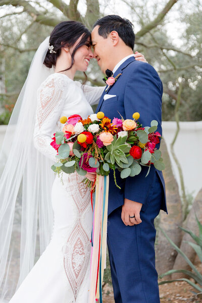 Bride and groom with bright floral bouquet at EL Chorro in Scottsdale
