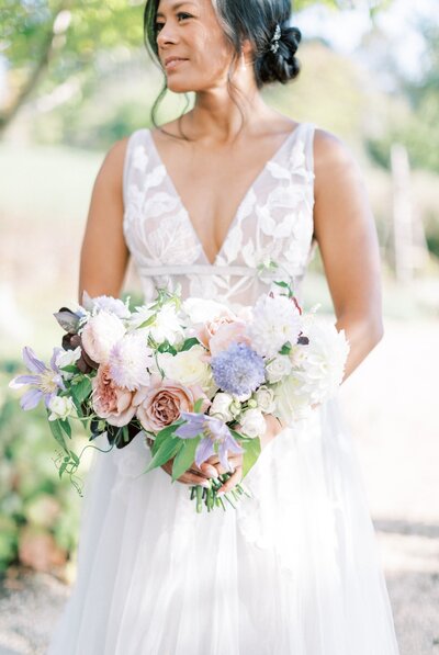 Bride holds a beautiful and pastel in color bouquet at Pippin Hill Vineyards.