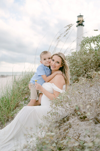 Mom hugging her toddler at the lighthouse by Miami Maternity Photographer