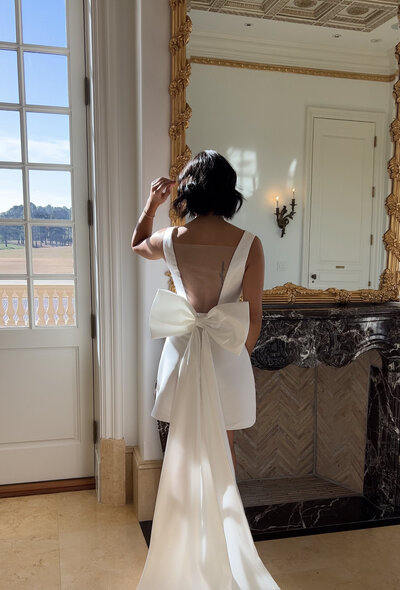 Short wedding dress posing in front of the fireplace at The Oxford wedding venue