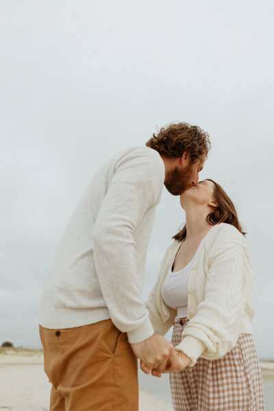 Photo of Kyra and her husband kissing and holding hands
