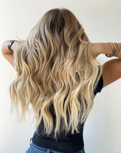 Close-up of blonde hair with dimensional balayage, highlighting expert coloring techniques offered at The Bob Salon in Fort Wayne.