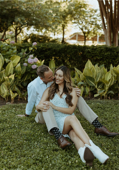 couple sitting on the ground snuggled up close