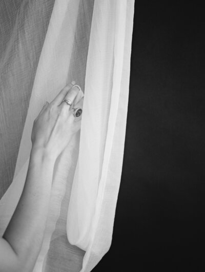 ethereal white curtain fabric, dark background, ornate gold heirloom jewelry, jeweler film brand photographer