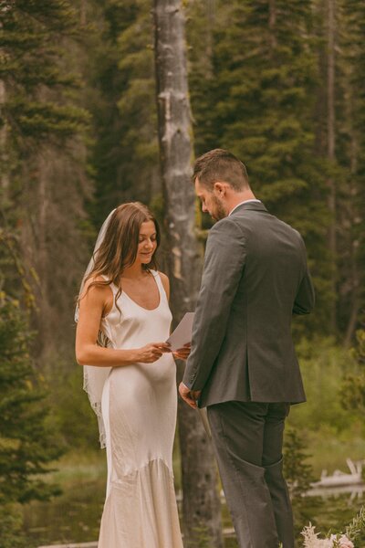 couple exchanging vows in the mountains at idaho elopement