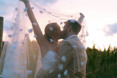 bride and groom kissing under a veil, wedding photography prices for elsie goodman photography