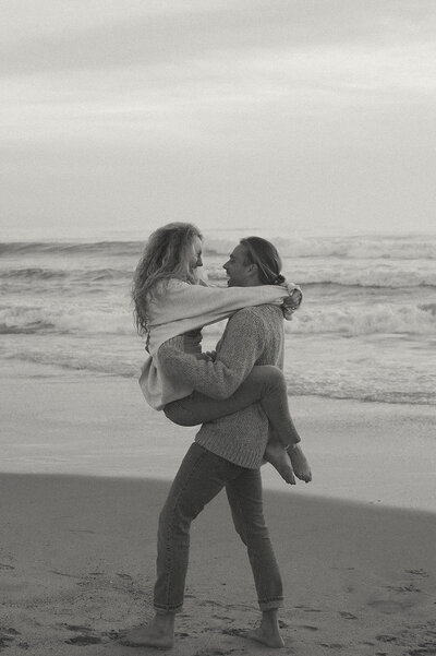 photo of couple running on beach in orange county