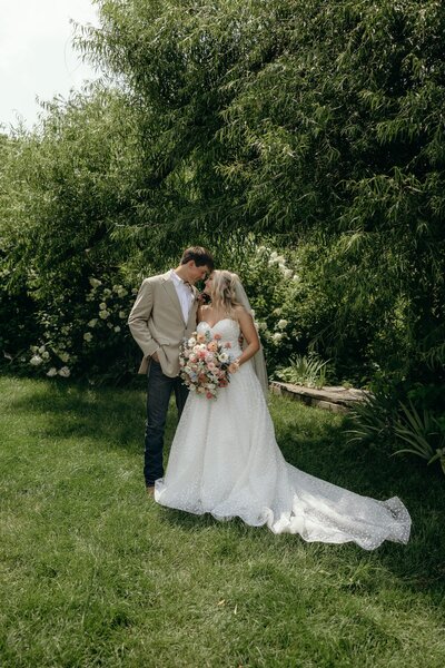 Bride and groom step into a horse-drawn carriage at their intimate rural wedding venue.